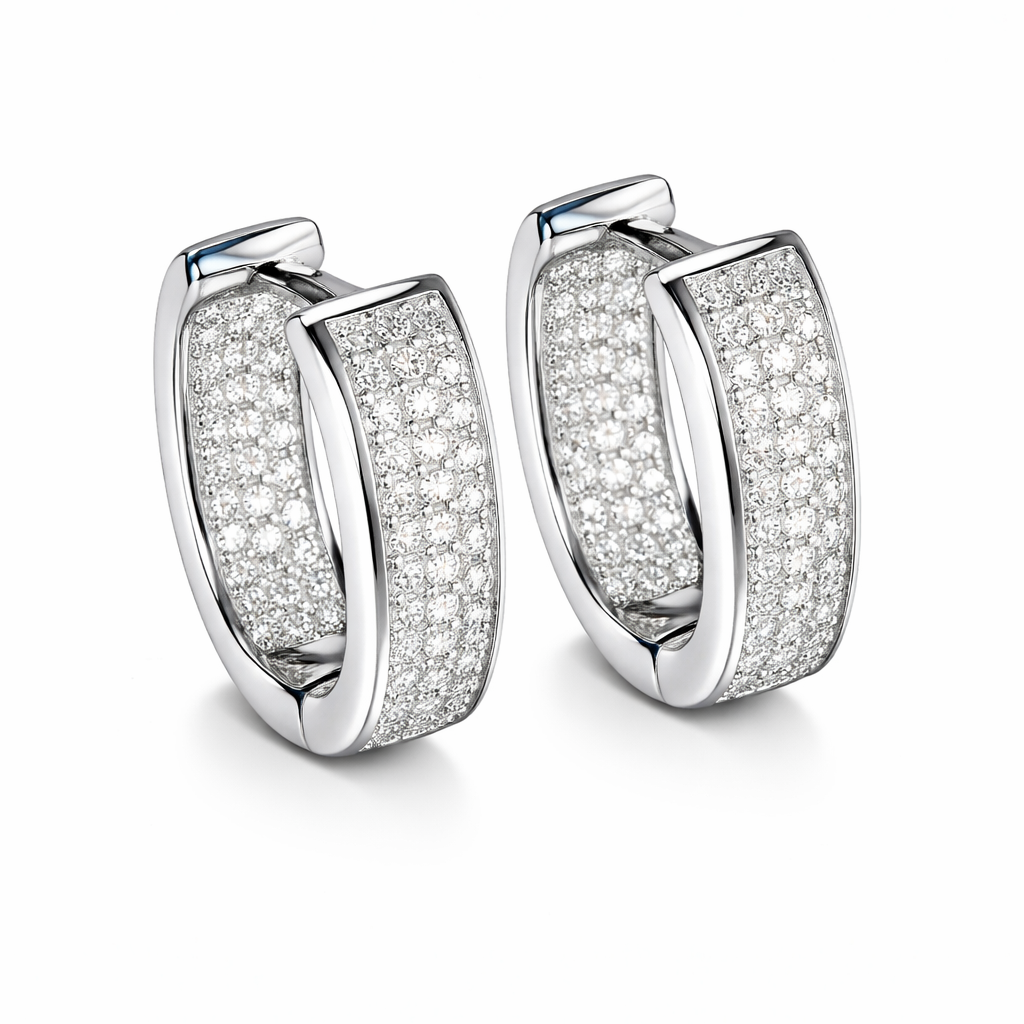 Pair of silver hoop earrings with clear gemstones on a white background

