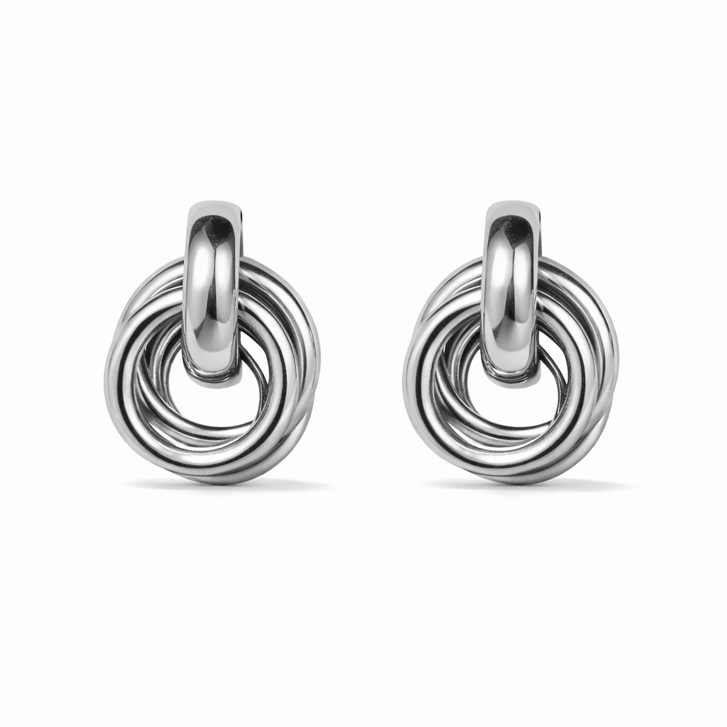 Knotted silver earrings on a white background