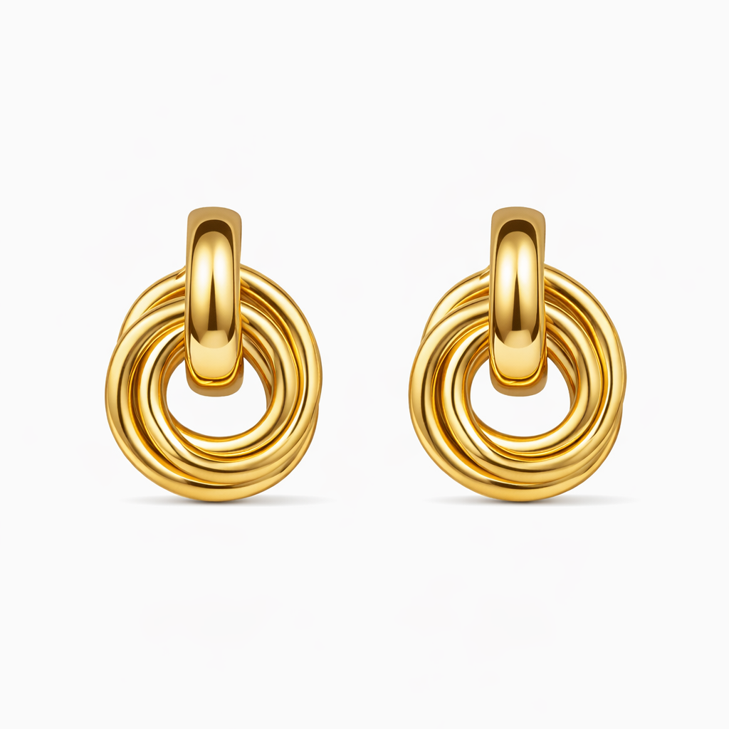Pair of gold hoop earrings on a white background

