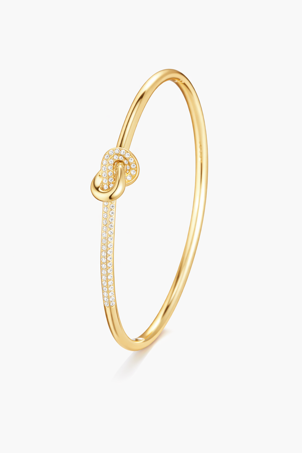 Gold bracelet with a knot design on a white background

