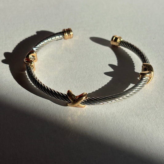 Gold and silver bracelet on a light gray background

