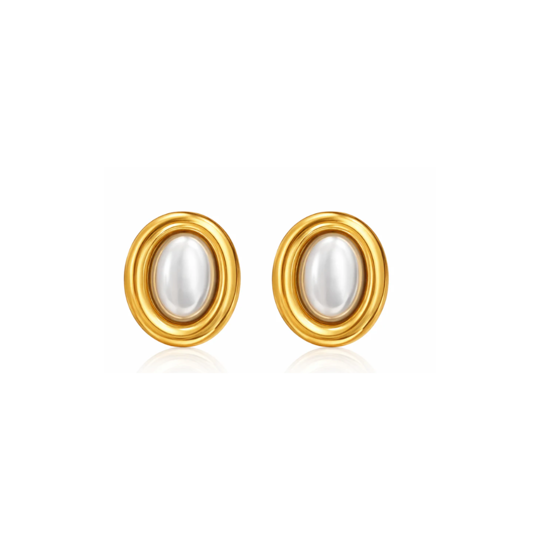 Pair of gold earrings with pearl centers on a white background. 
