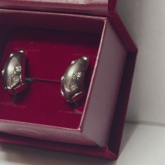 Two silver spoons in a red box on a white background
