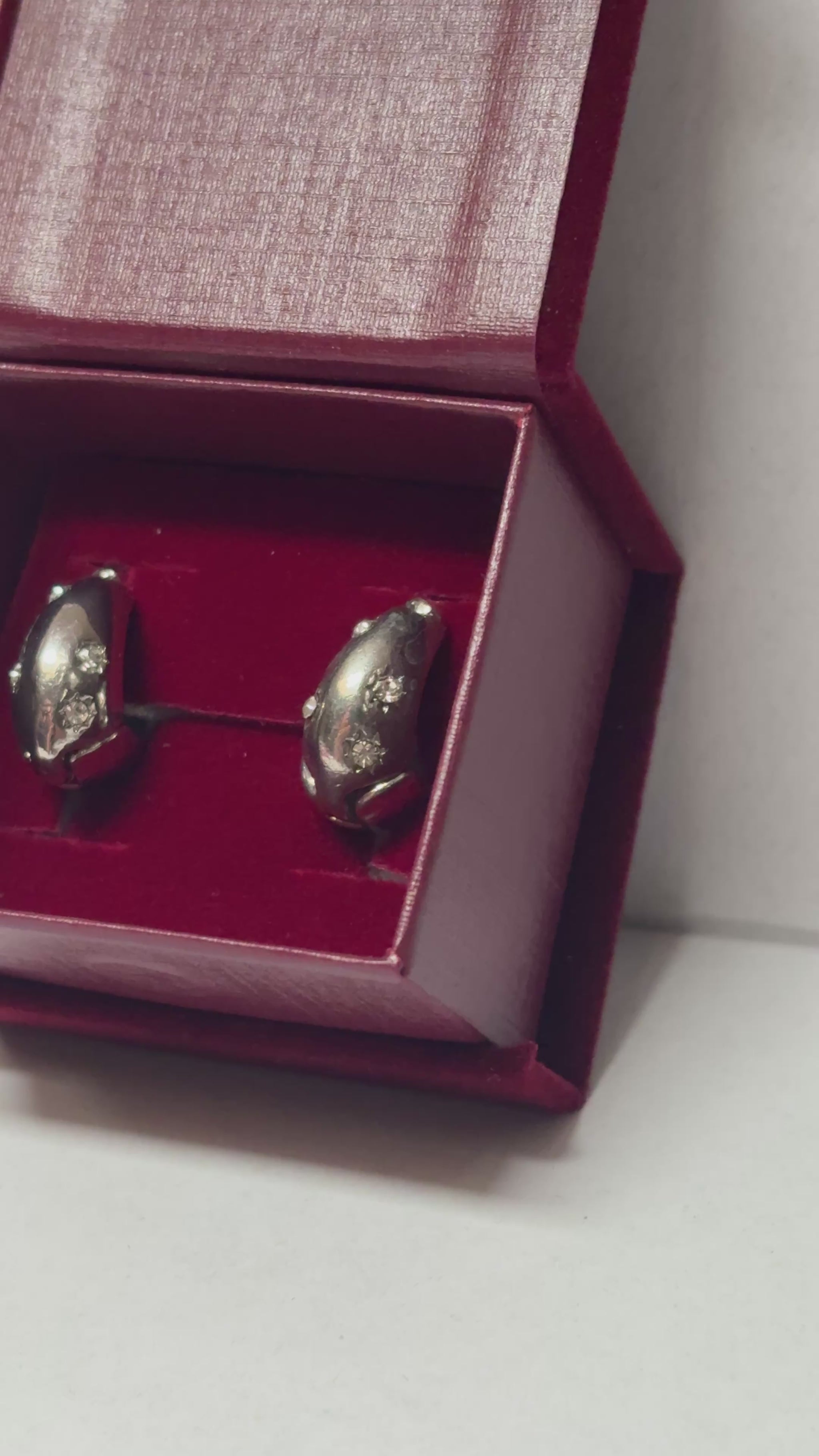 Two silver spoons in a red box on a white background
